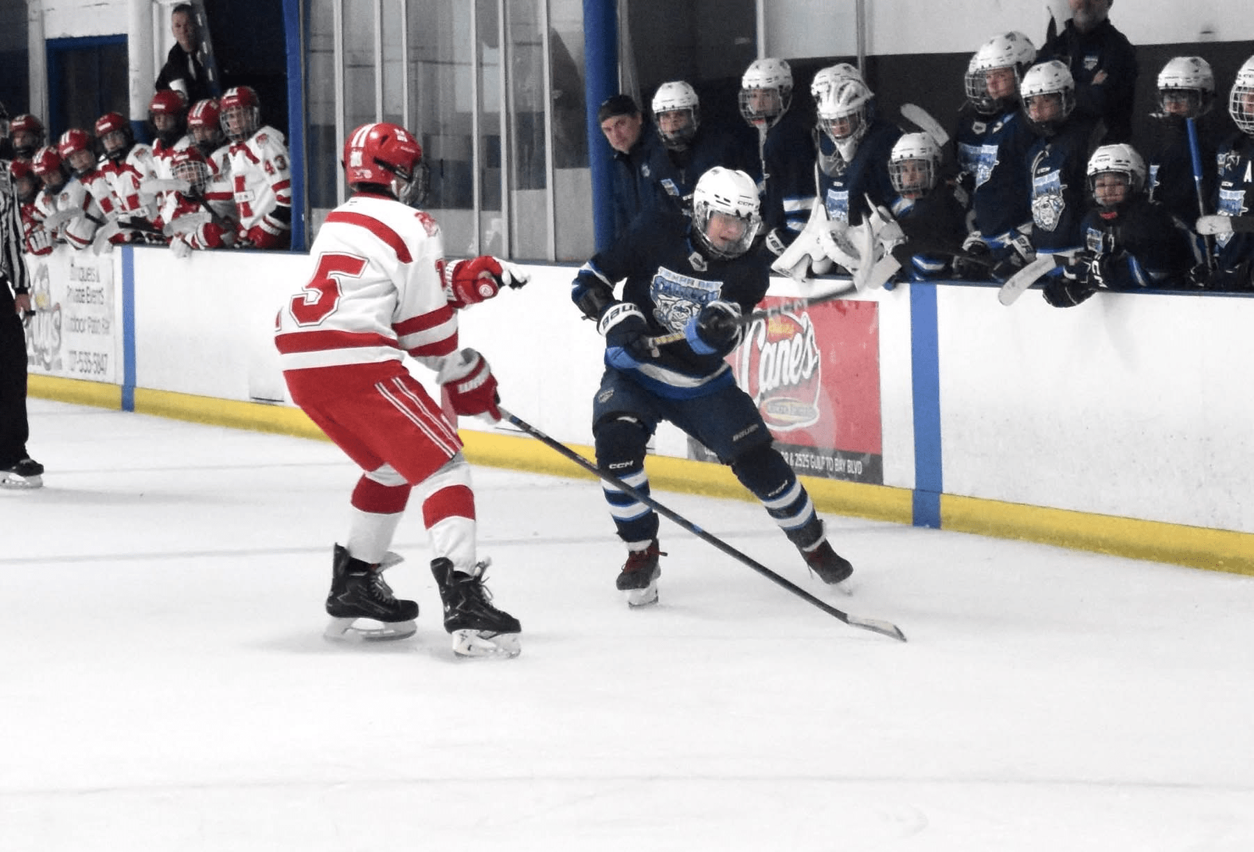 Kyle Tyson battling for the puck along the boards